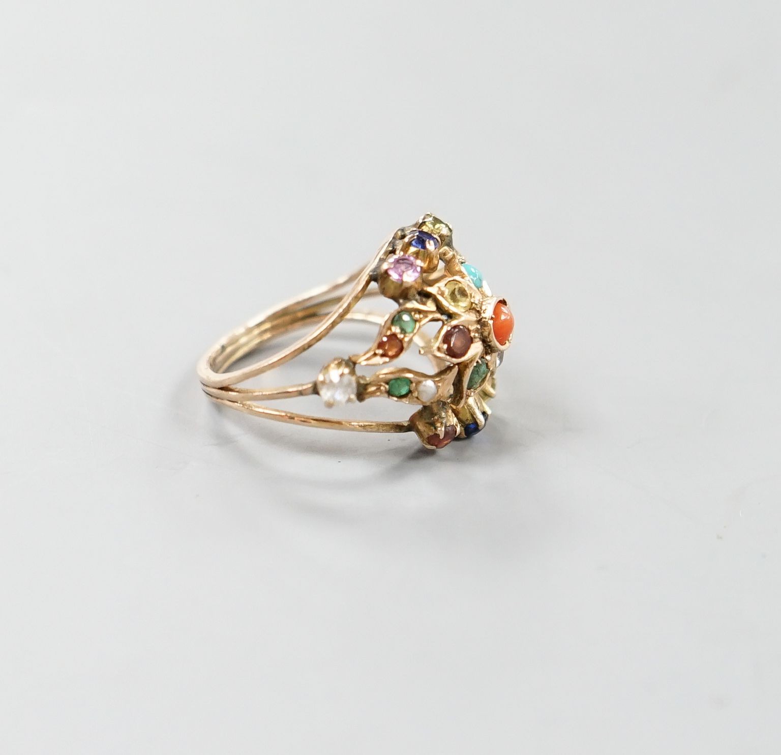 An early 20th century Arts & Crafts yellow metal and multi gem set set cluster ring, size H/I, gross weight 3.6 grams.